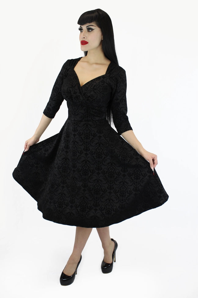 Black fit and flare dress with sleeves front view