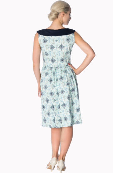 Woman wearing a patterned dress with a white background