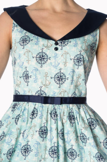 Dress with nautical pattern featuring anchors and compasses on a light blue background.