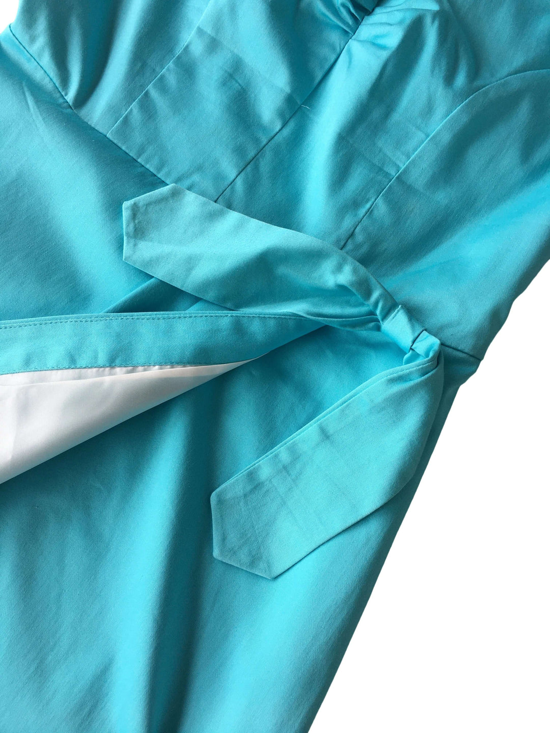 Close-up of a turquoise shirt with a pocket on a white background