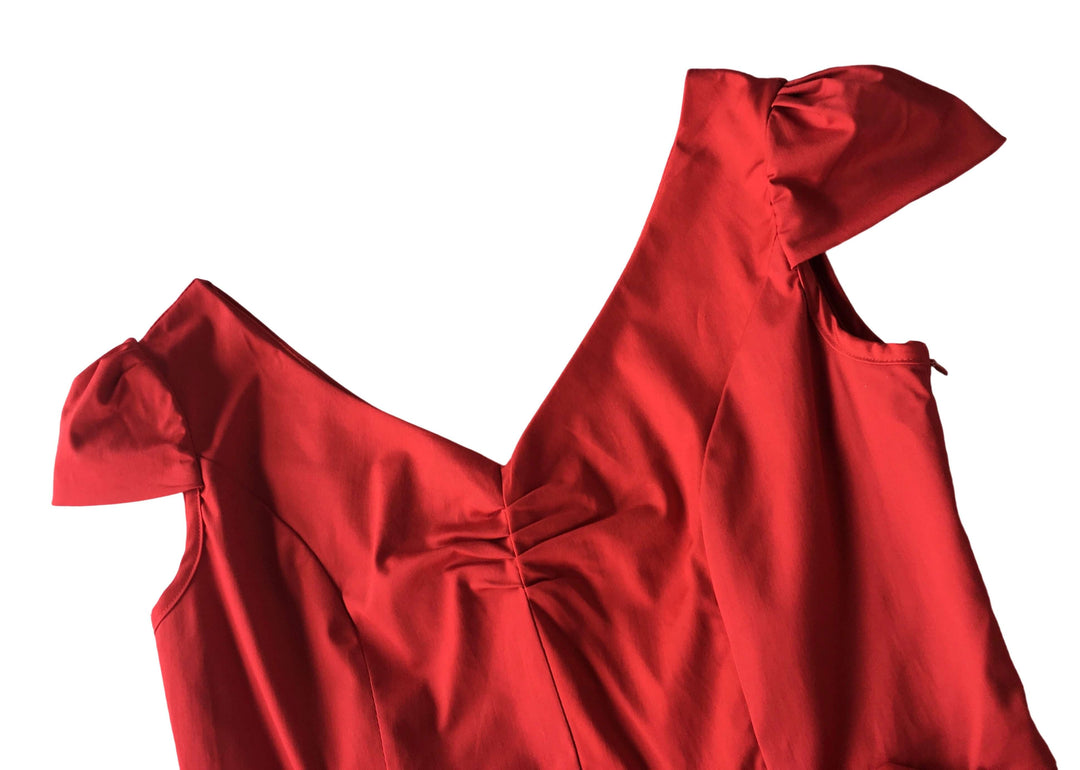 Maisie Red Pencil Dress featuring bow-tied cap sleeves and vintage V-neck design on a vibrant red fabric.