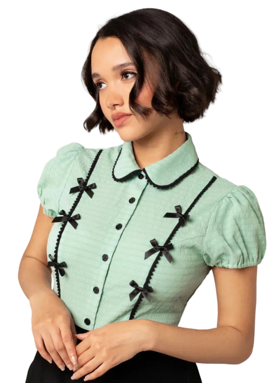 Hell Bunny Casey mint green blouse with black ribbon bows, black trim collar and button front worn by model