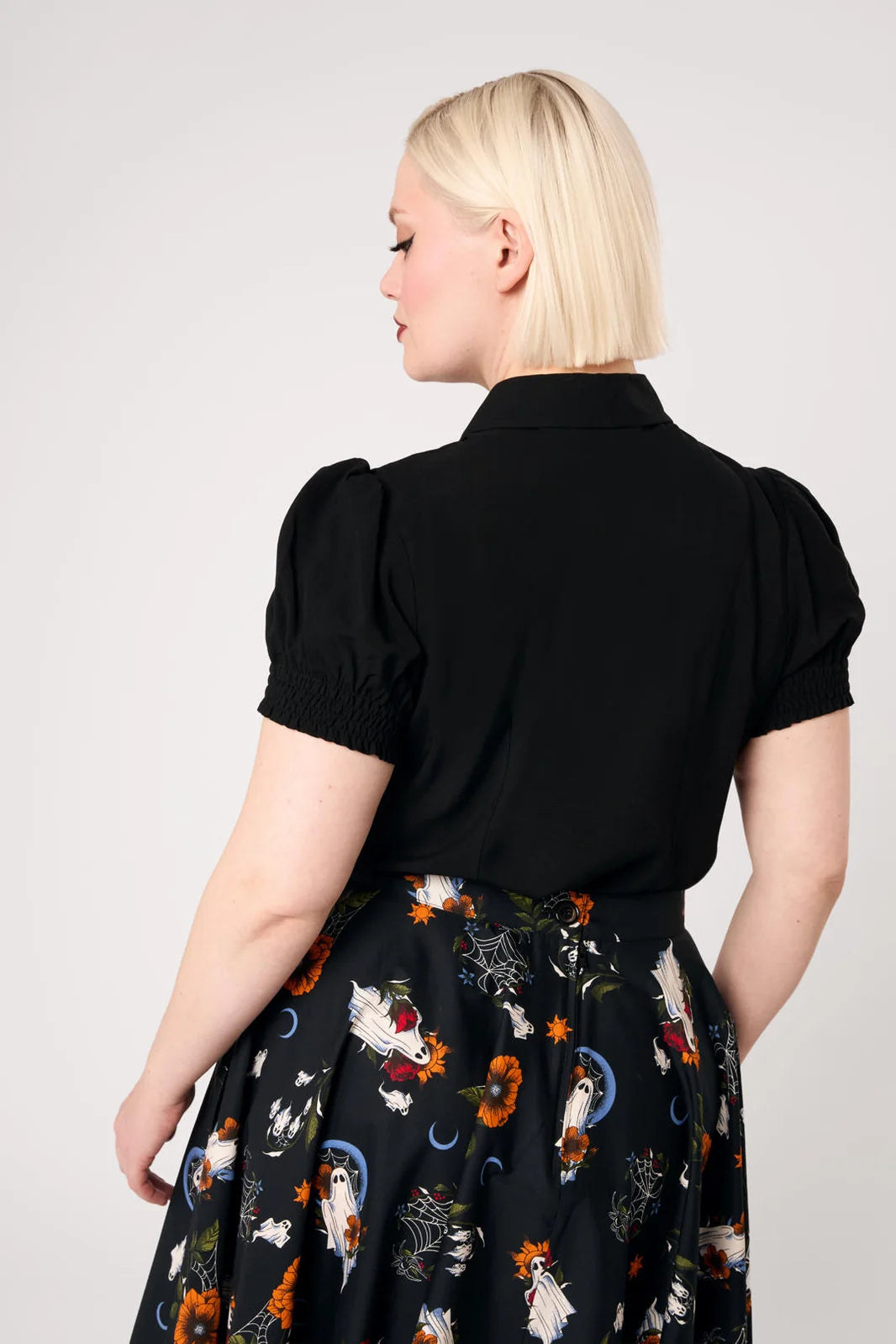 Back view of Hell Bunny Ghost Flower black blouse with short puff sleeves