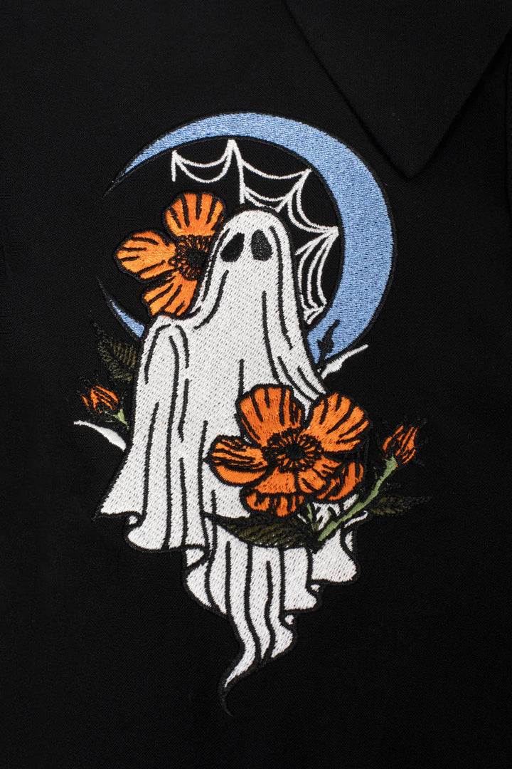 Close up of Hell Bunny Ghost Flower Blouse with embroidered ghost, flowers and orange buttons
