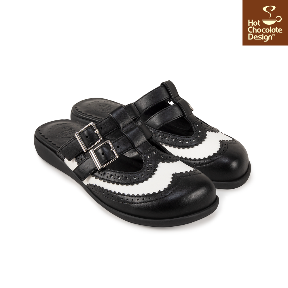 Black and white sandals with buckles on a white background, featuring Hot Chocolate Design logo.