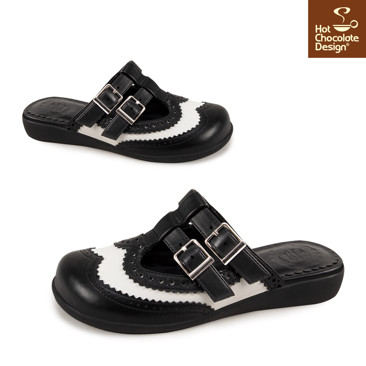 Black and white sandals with buckles on a white background, featuring Hot Chocolate Design logo.
