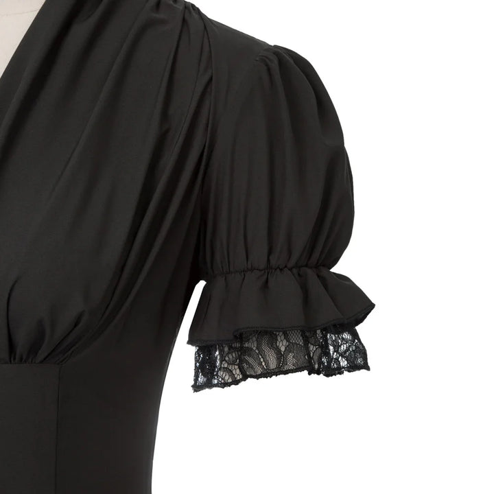 Black dress with lace detailing on a white background