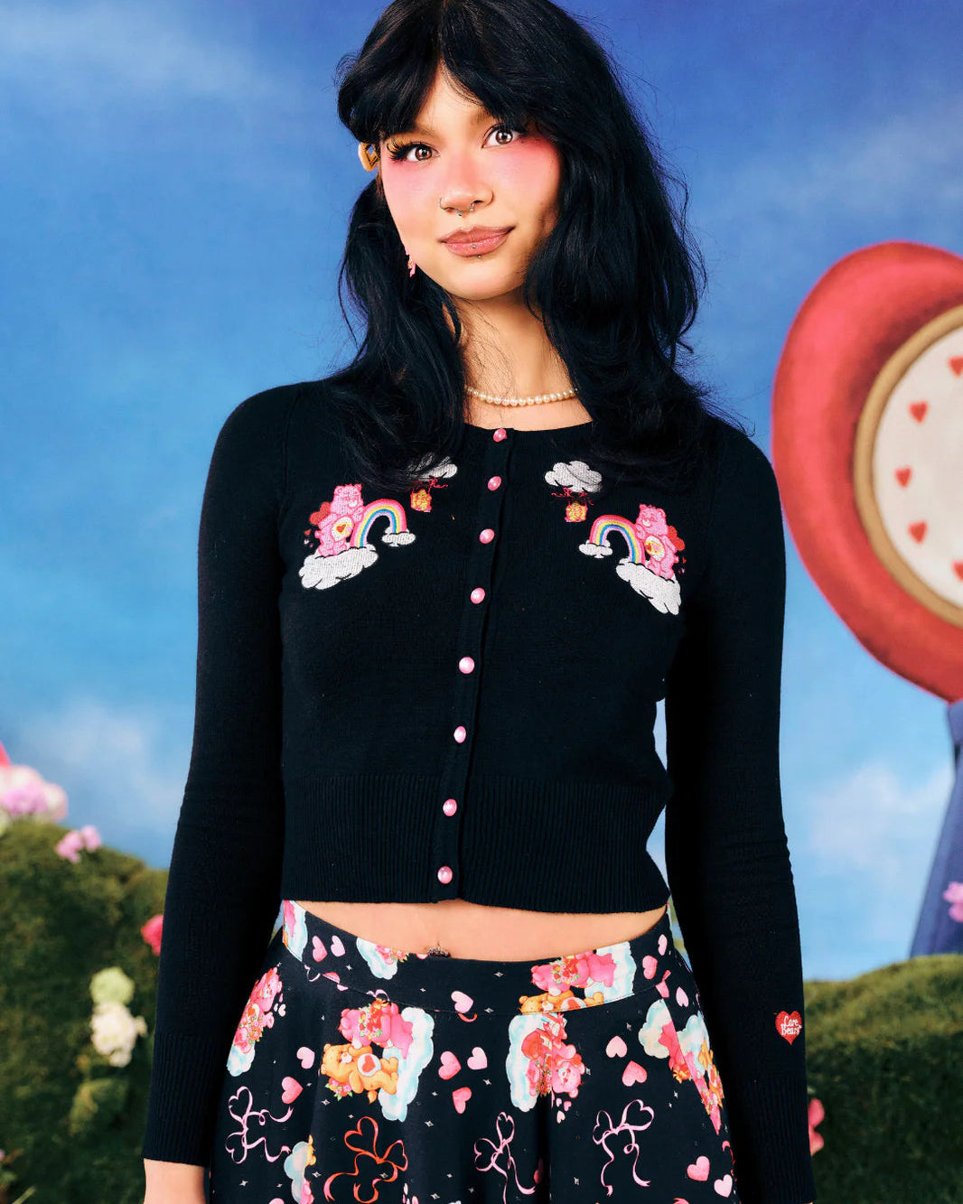 Hell Bunny x Care Bears™ Love-A-Lot black cropped cardigan with pink buttons and embroidered Love-a-Lot Bear rainbow cloud detail