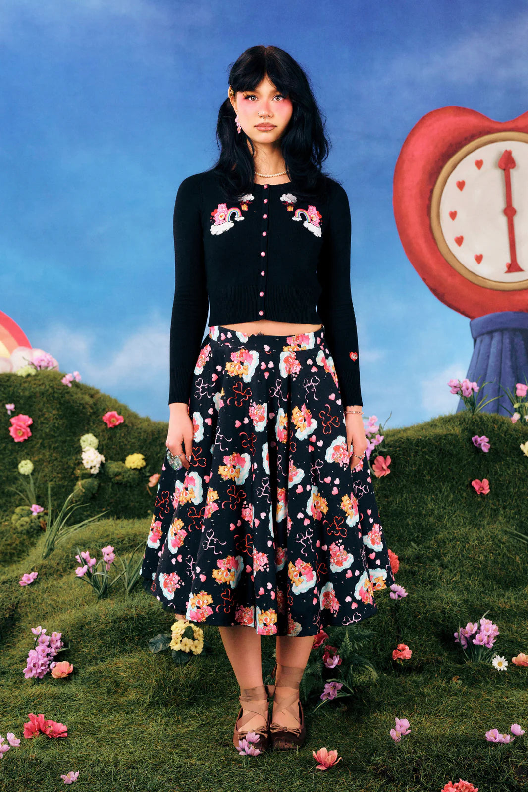 Woman in a floral outfit standing in a whimsical garden with a large clock in the background