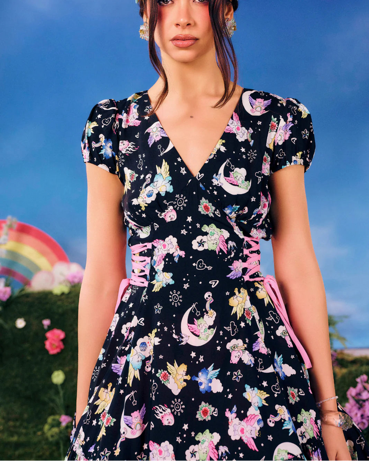 Hell Bunny x Care Bears™ Roxi black printed mini dress with V-neckline, pink corset-style waist ties and puff sleeves