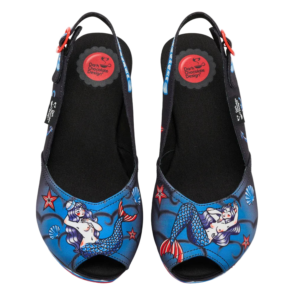 Pair of blue mermaid-themed shoes with black soles on a white background, featuring Dark Chocolate Design logo.