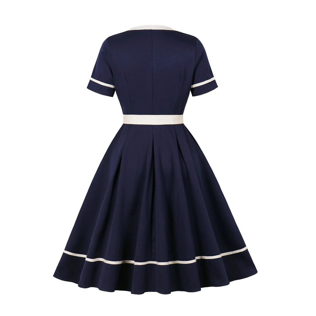 Navy blue dress with white trim on a white background