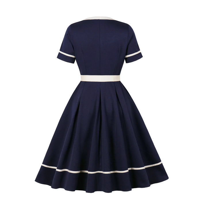 Navy blue dress with white trim on a white background