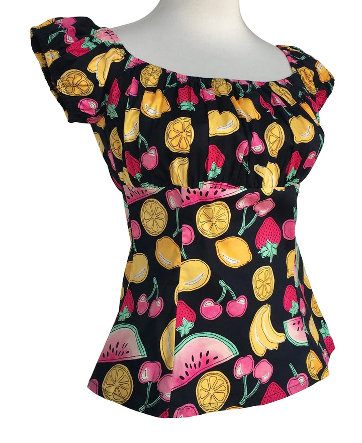 Black top with colorful fruit pattern on a white background