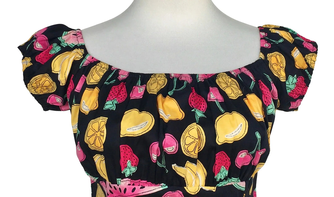 Close up of Tutti Frutti fruit print fabric ruched bust peasant style top