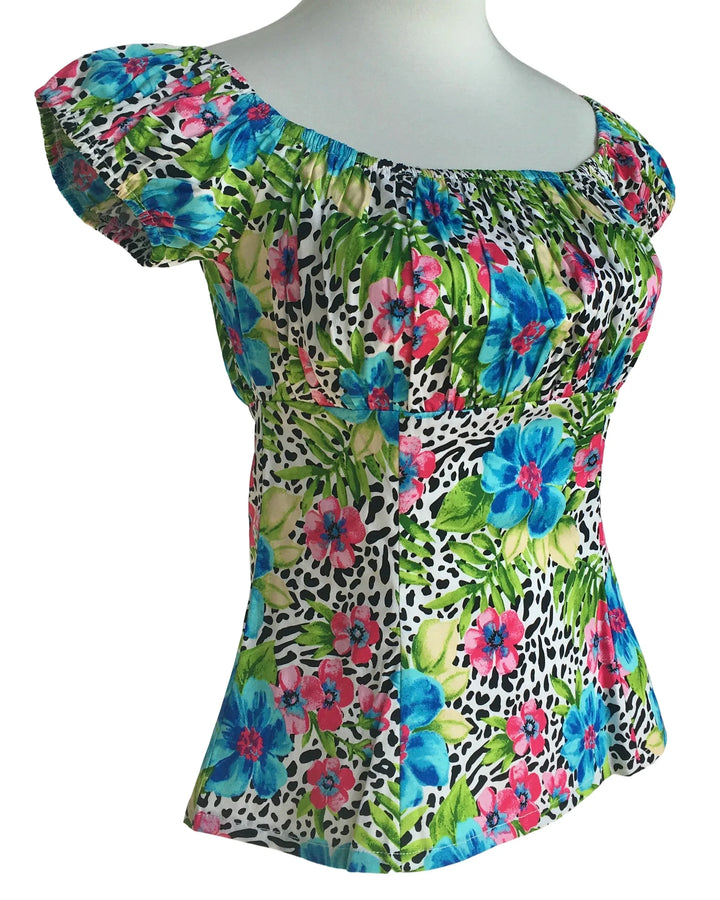 Colorful floral and leopard print top on a mannequin against a white background