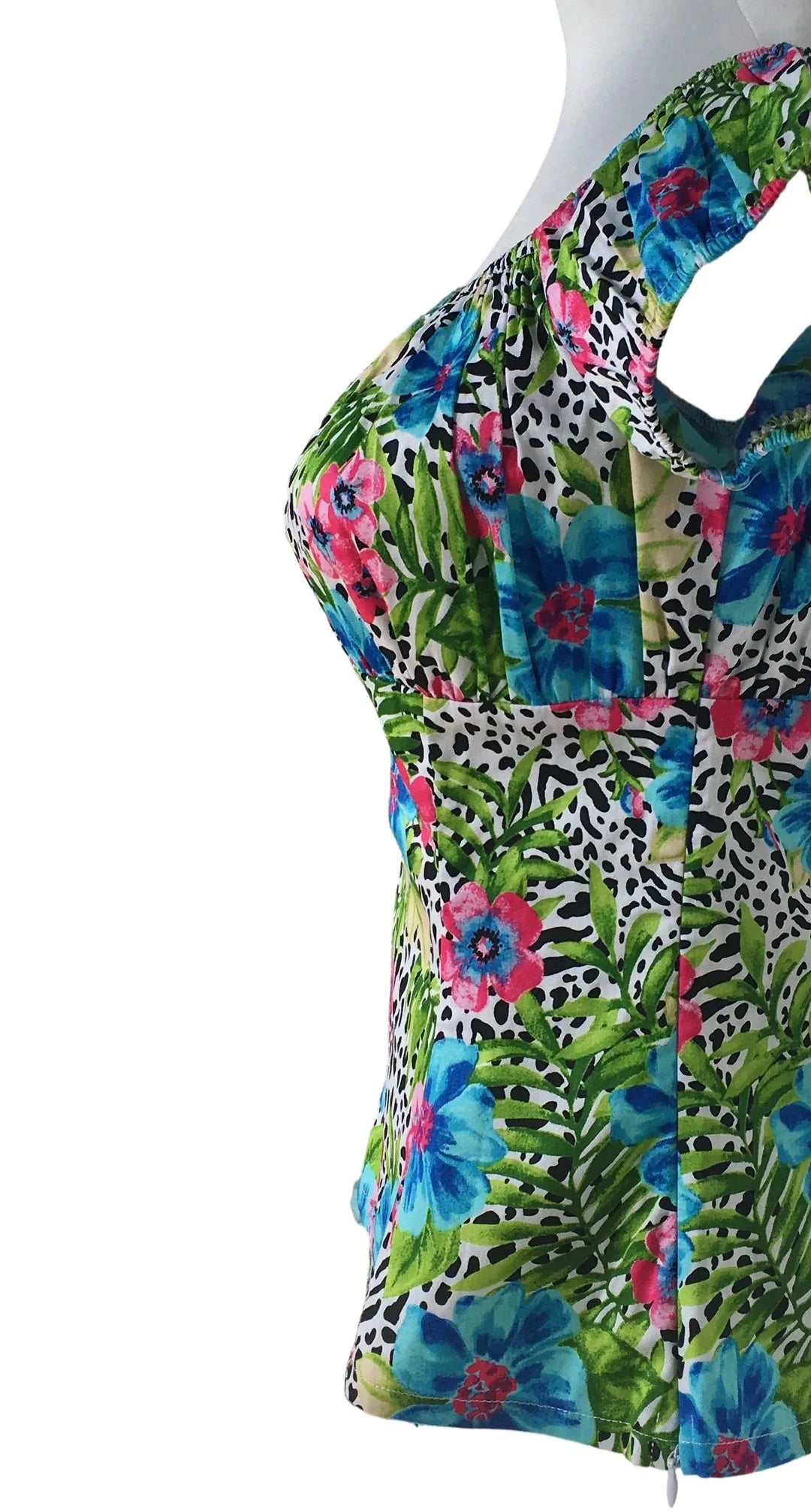 Colorful floral and animal print top on a mannequin against a white background