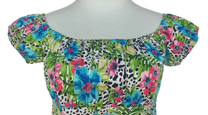 Multicolored floral and animal print top on a mannequin against a white background