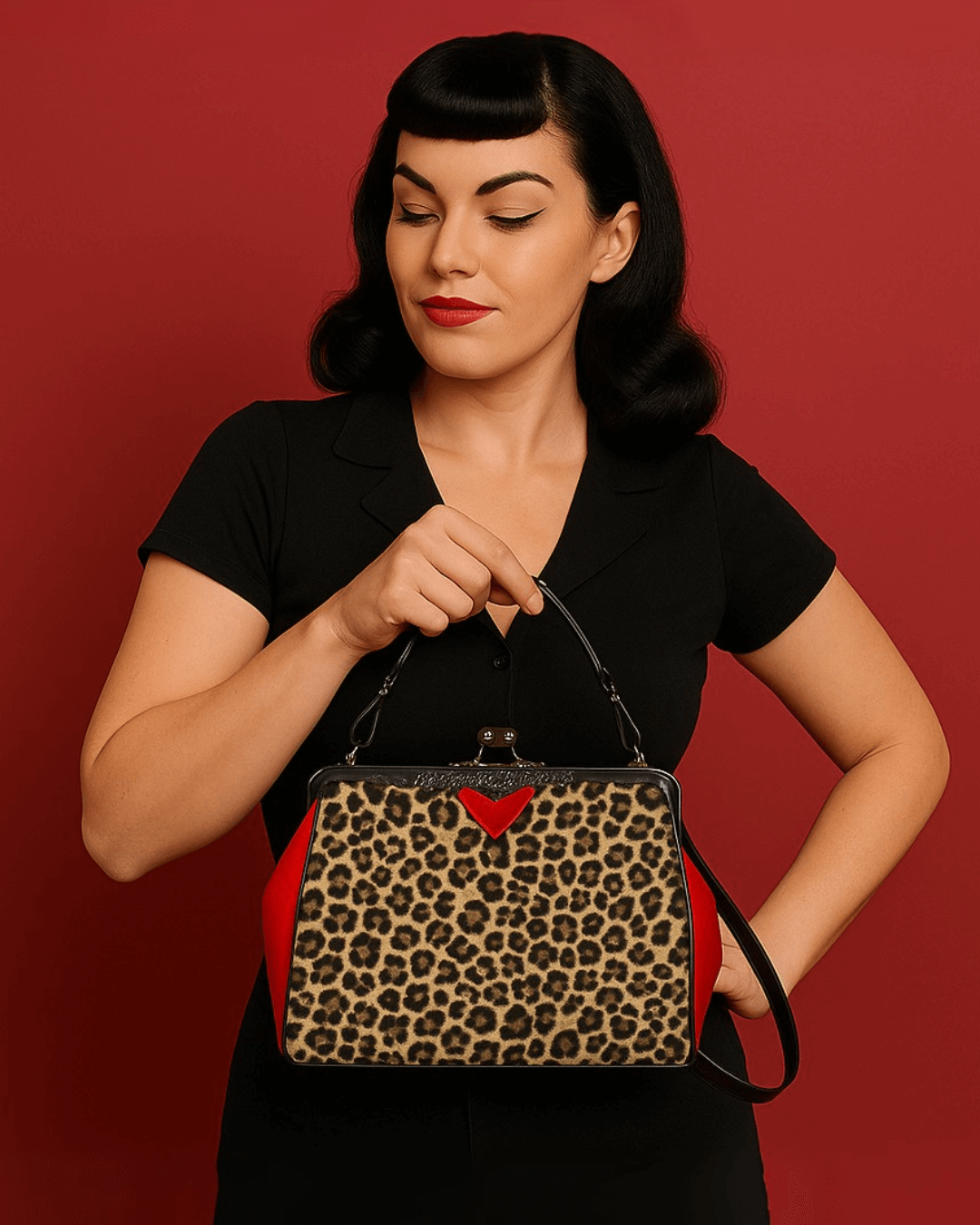 Kisslock vintage handbag in leopard print held by a woman in retro style against a red background.