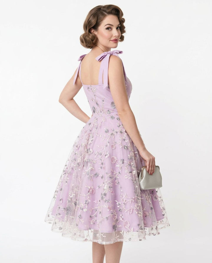 Woman wearing a lavender floral dress on a white background