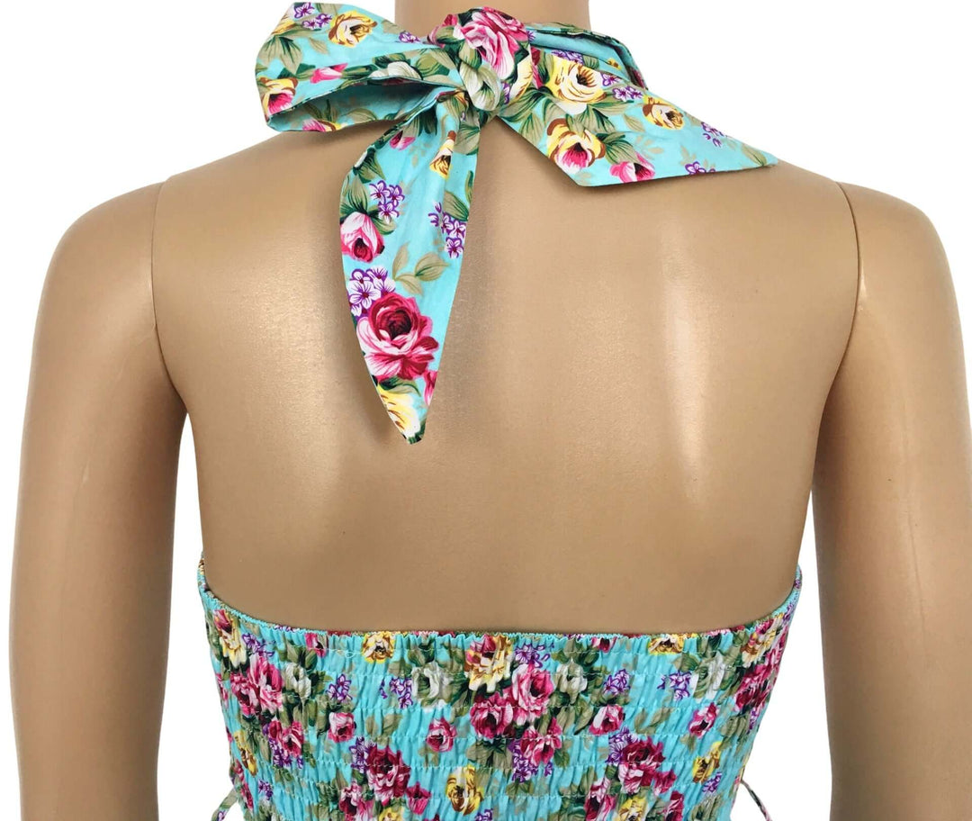 Aqua Floral Rockabilly Swing Dresses featuring a tied halter neck and vibrant floral pattern on a vintage-inspired design.