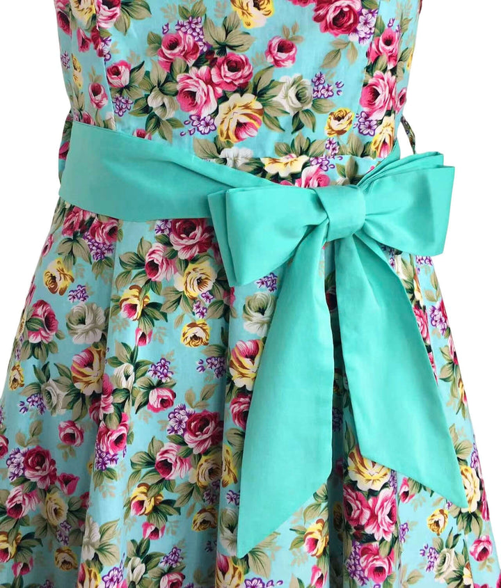Aqua Floral Rockabilly Swing Dresses features a beautiful aqua bow on a floral dress, perfect for vintage-inspired looks.