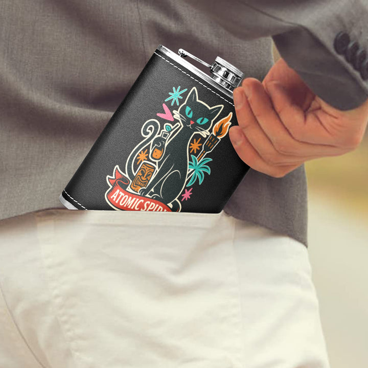 Person placing Atomic Spirit 8 oz black hip flask with retro design into their pocket.