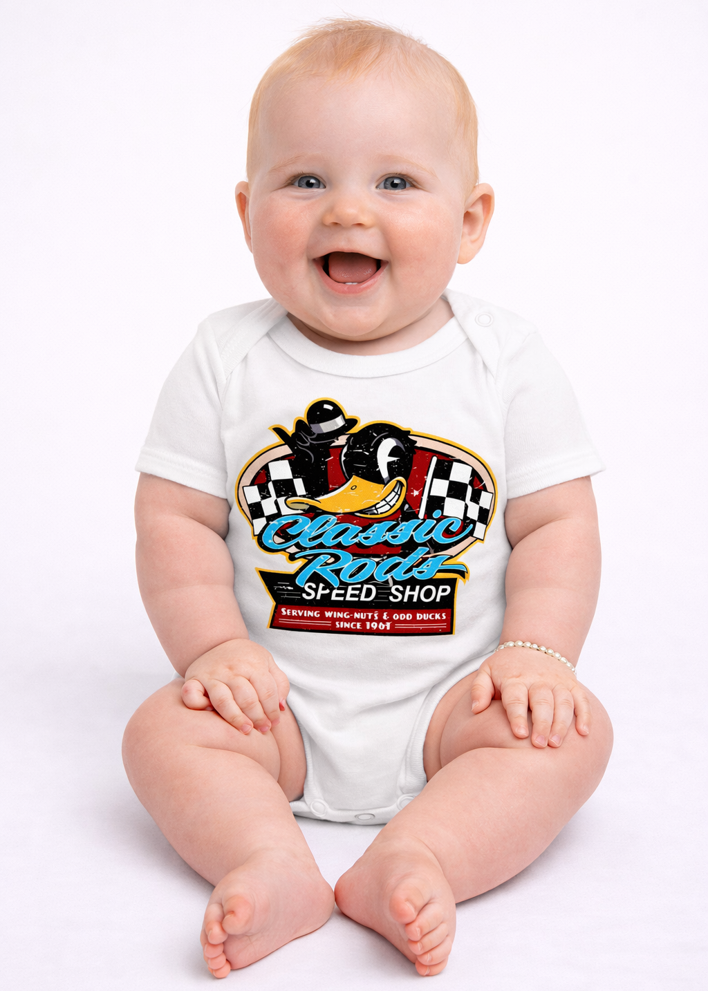 Baby wearing a white onesie with a colorful graphic design on a white background