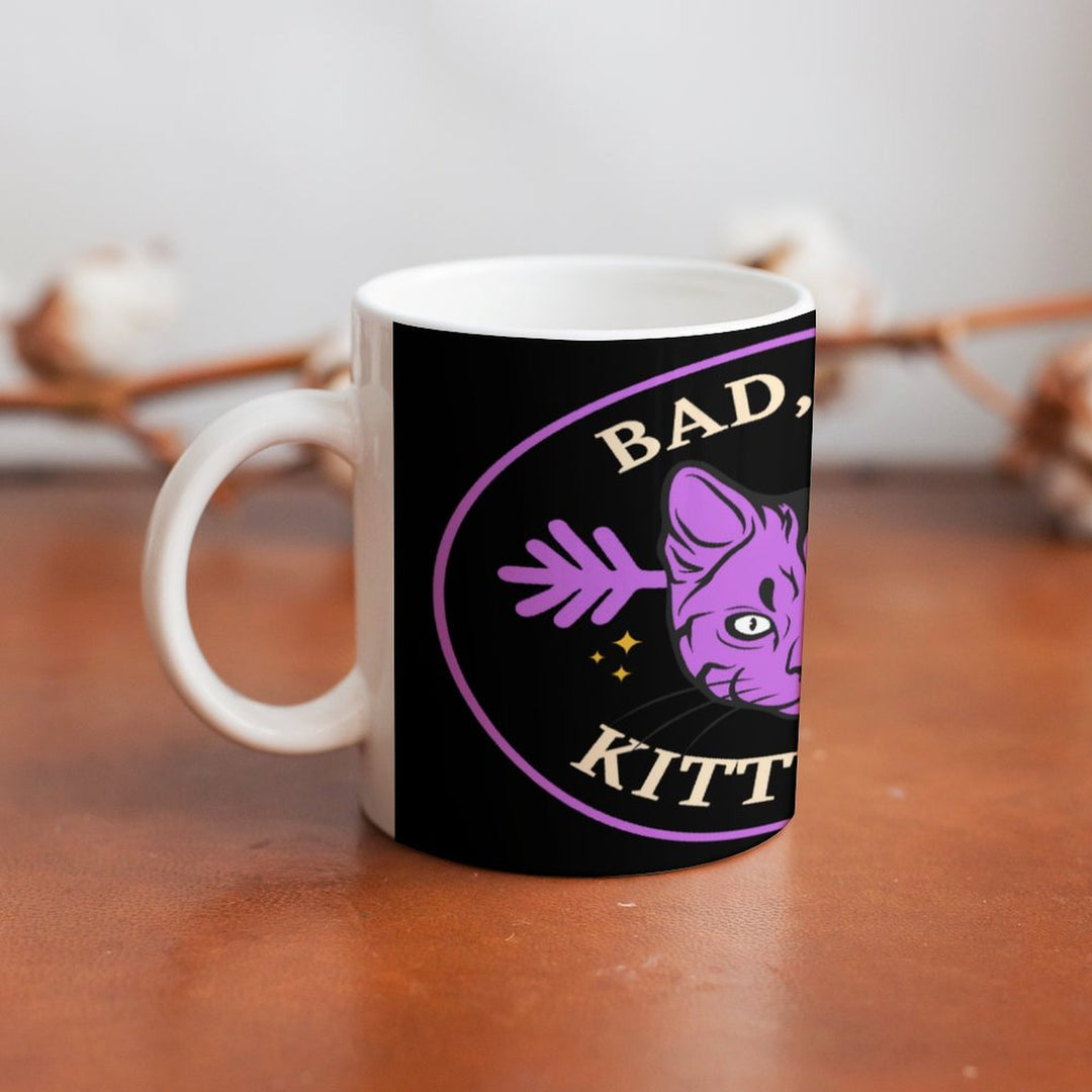 Bad Bad Kitty Cat ceramic mug featuring a purple cat design, perfect for coffee or tea. Retro coffee mug, 16.9 oz capacity.