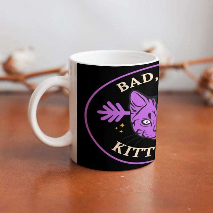 Bad Bad Kitty Cat ceramic mug featuring a purple cat design, perfect for coffee or tea. Retro coffee mug, 16.9 oz capacity.
