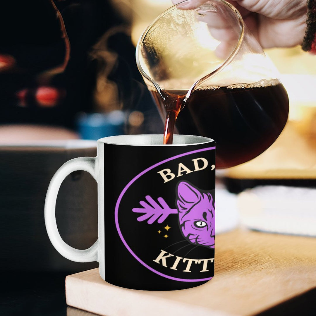 Bad Bad Kitty Cat White Mug being filled with coffee, featuring a playful cat design and a retro style.