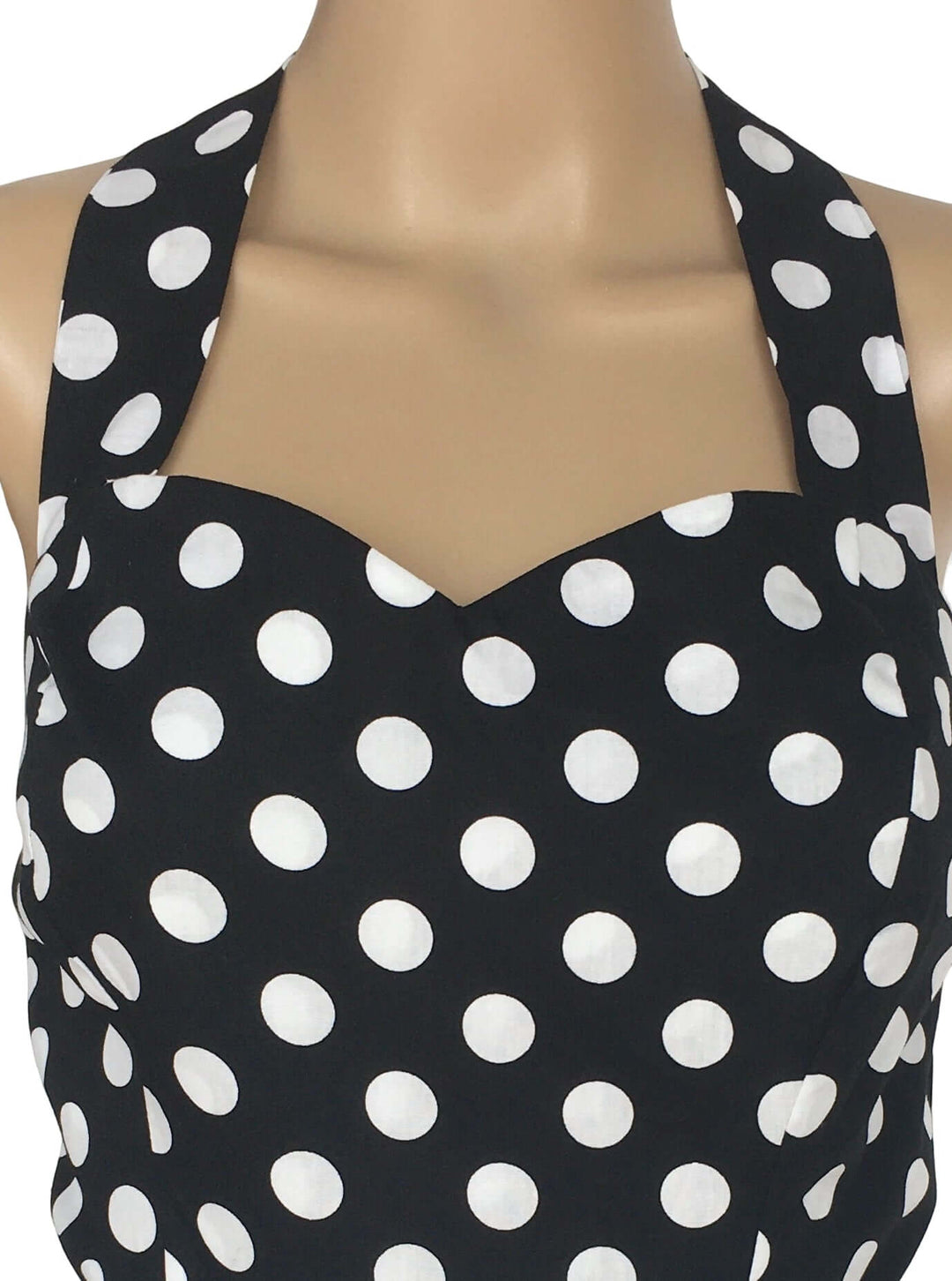 Black Polkadot Rockabilly Swing Dresses close-up of halter neckline with white polka dots on black fabric