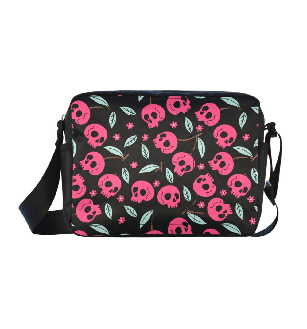 Cherry Skulls Crossbody Bag with pink skulls and green leaves on a black background, perfect for edgy style and daily use.