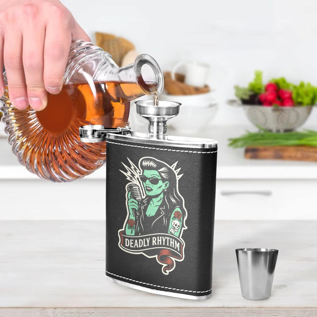 Pouring whiskey into a Deadly Rhythm 8 oz black hip flask with a sleek design in a kitchen setting.