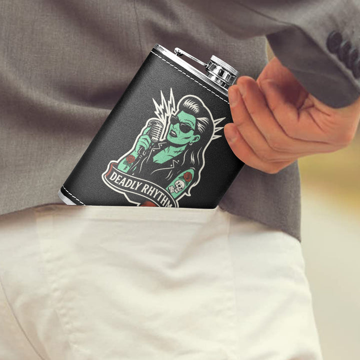 Deadly Rhythm 8 oz black hip flask with retro design being placed in pocket, perfect for stylish hydration.