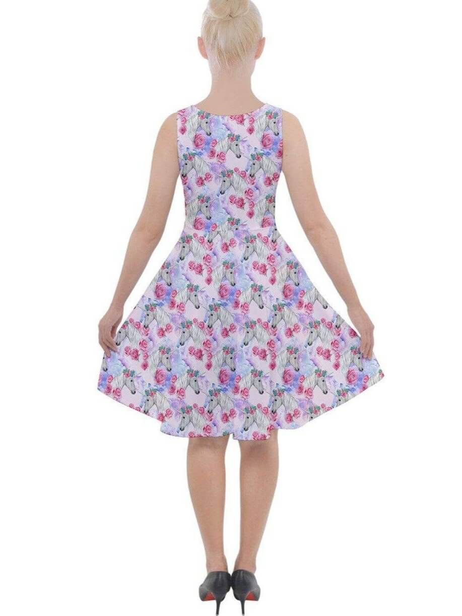 Back view of a ladies' knee-length skater dress with colorful unicorn and floral prints, featuring a flared skirt design.