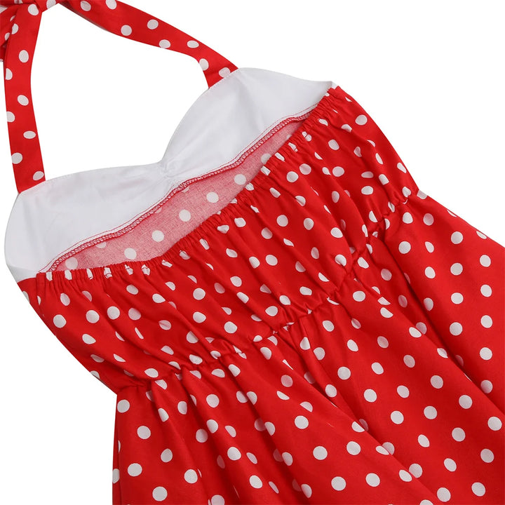 Red polka dot halter dress featuring an elastic back and A-line silhouette, perfect for girls' twirling fun.