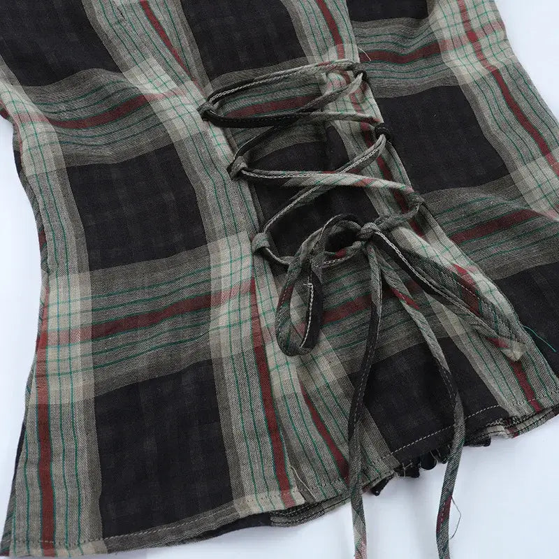Gothic Plaid Ruffle Blouse showcasing the unique back corset-style lace-up detail and plaid pattern.