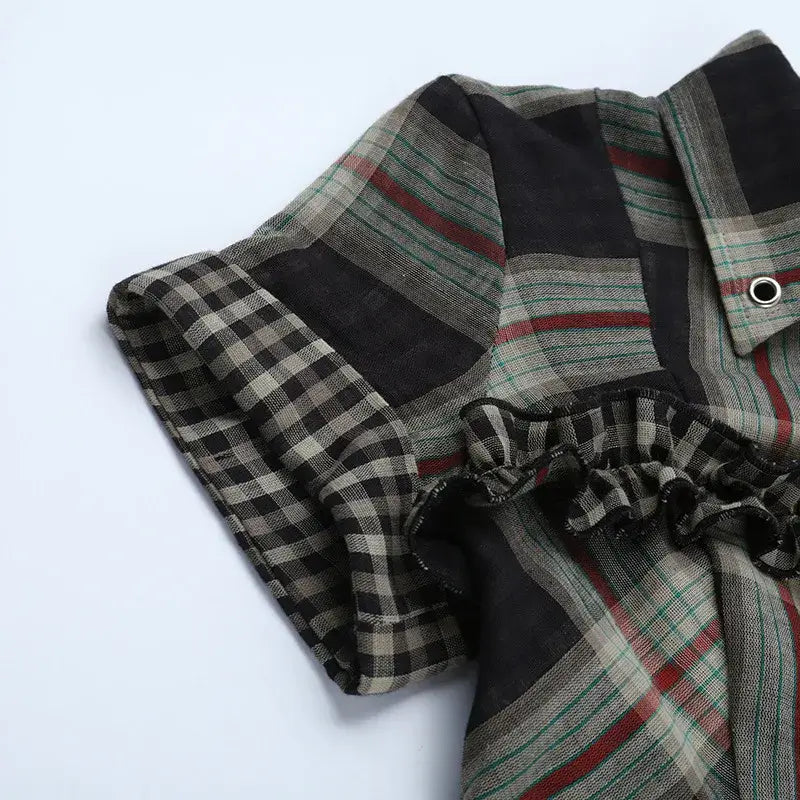 Close-up of Gothic Plaid Ruffle Blouse showcasing the plaid pattern and ruffle trim details.