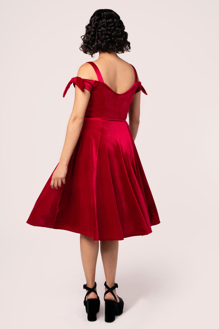 Back view of Hell Bunny Carrie red velvet midi dress on model