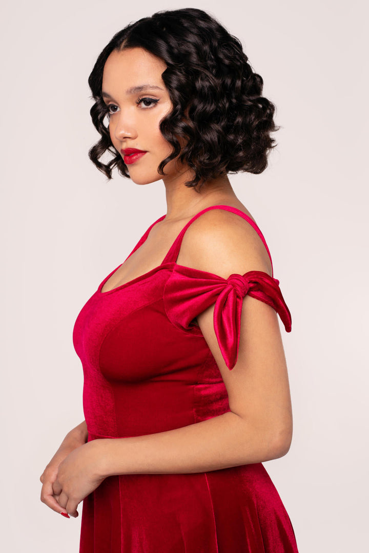 Close view of Hell Bunny Carrie red velvet dress bodice and bow shoulder strap