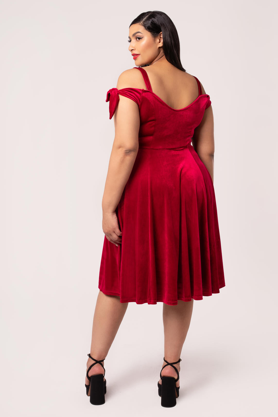 Detail view of Hell Bunny Carrie red velvet dress on plus size model