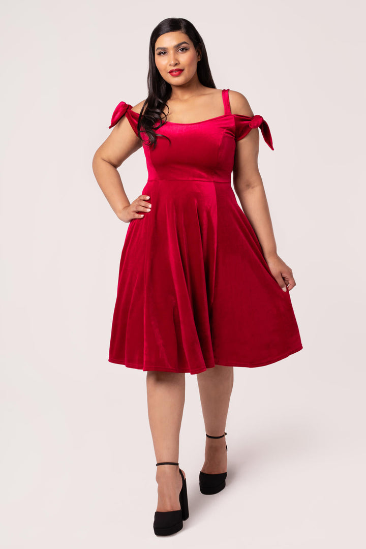 Front view of Hell Bunny Carrie red velvet midi dress on plus size model