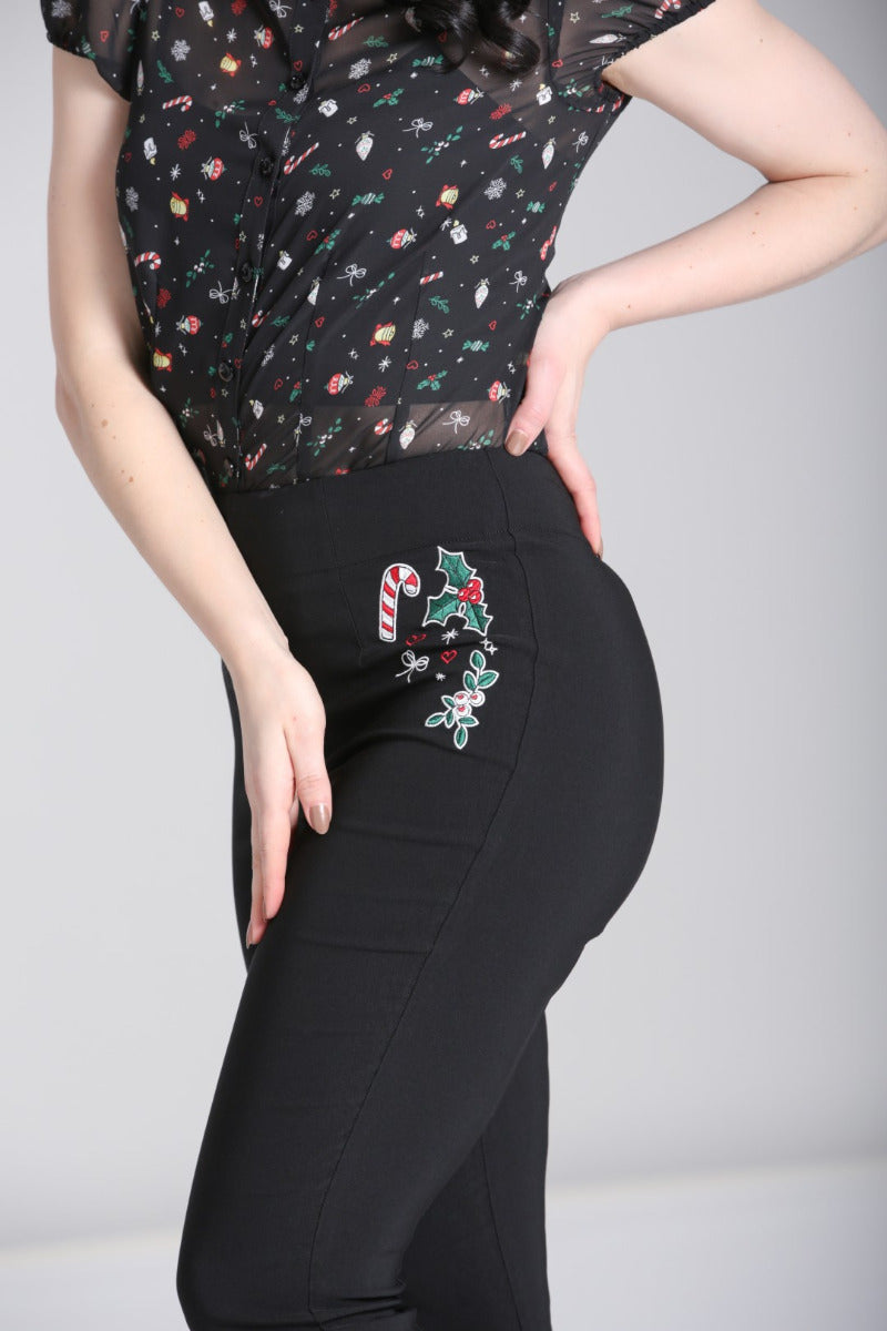 Model wearing Hell Bunny Natalie black high waisted Christmas capris with festive embroidery