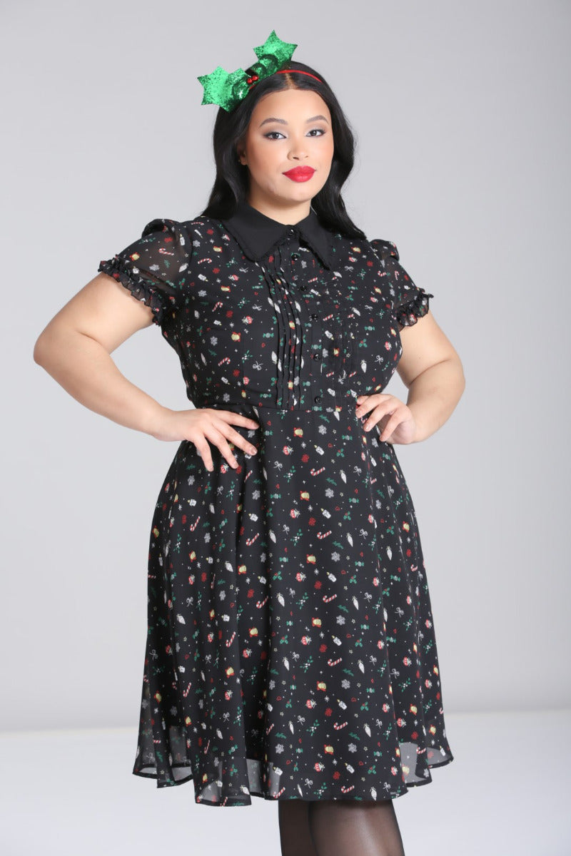 Plus-size model wearing the Hell Bunny Natalie black Christmas chiffon midi dress with festive print