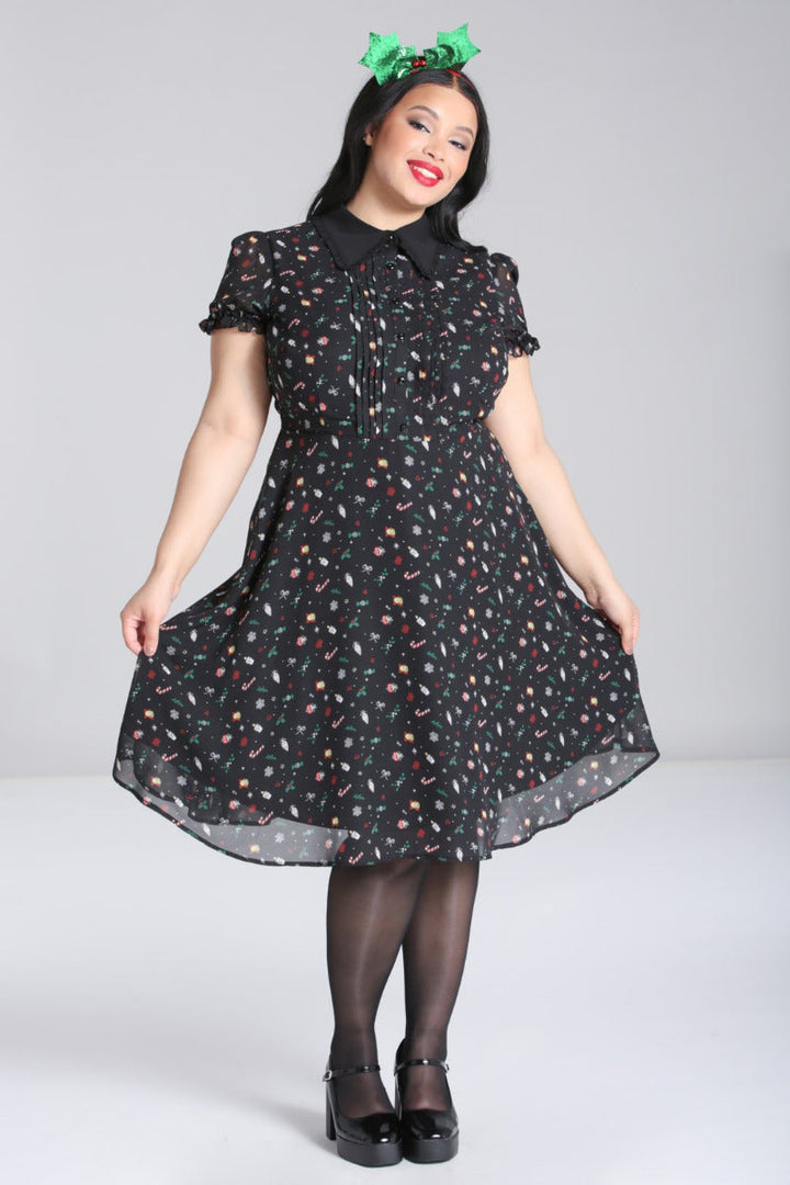 Plus-size model showing the flared skirt and movement of the Hell Bunny Natalie black festive midi dress
