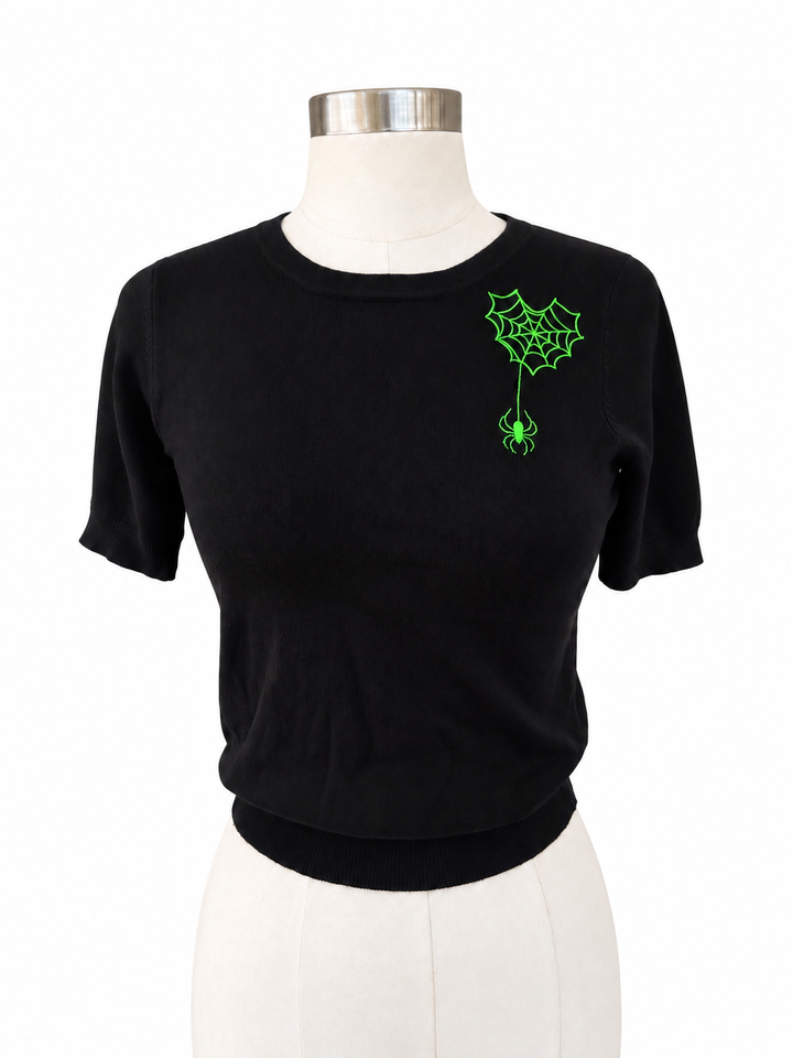 Hemet green spiderweb embroidered black knit top on white background