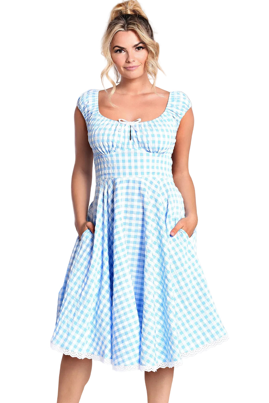 Woman wearing a blue and white checkered dress on a plain background