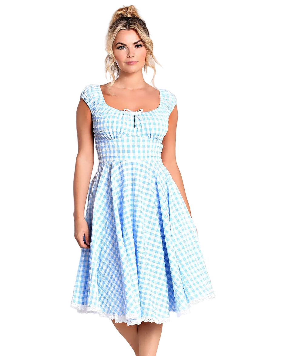 Woman wearing a blue and white checkered dress on a plain background