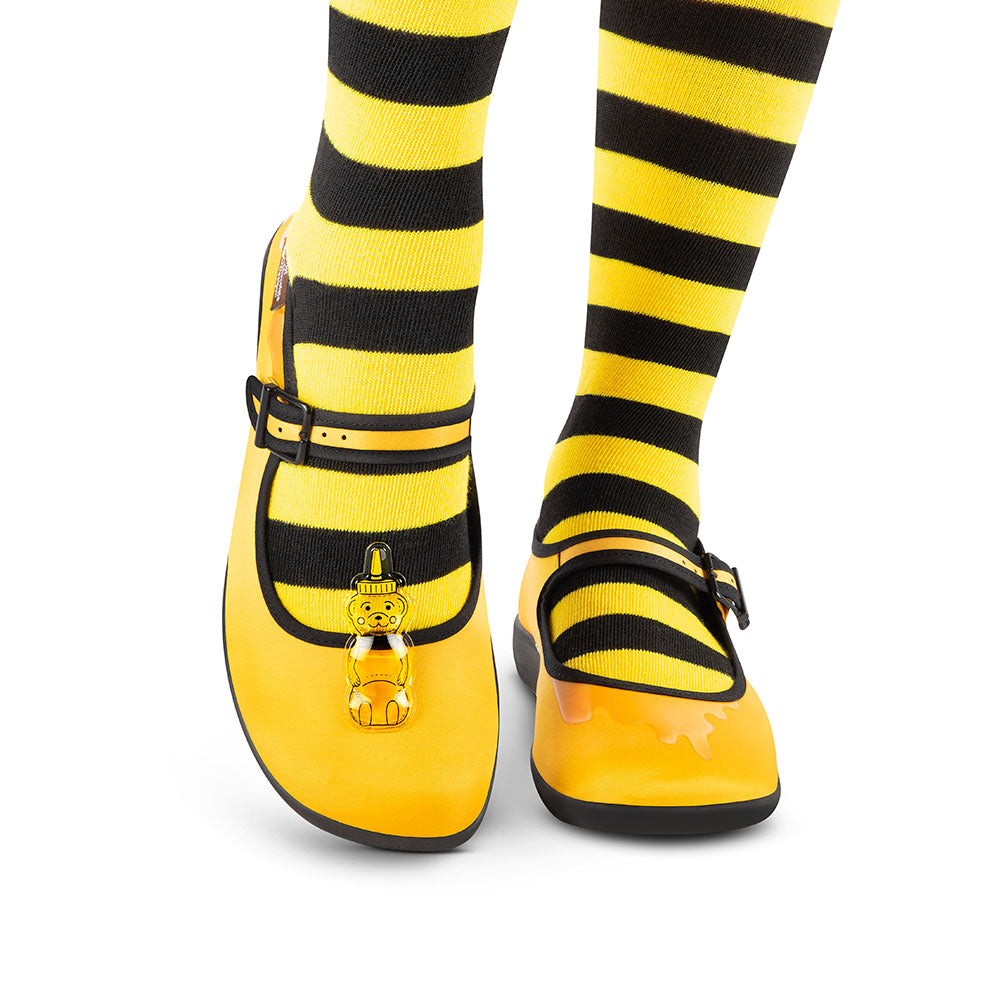 Hot Chocolate Design Oh Honey! shoes paired with black and yellow striped socks, featuring a honey bear accessory.
